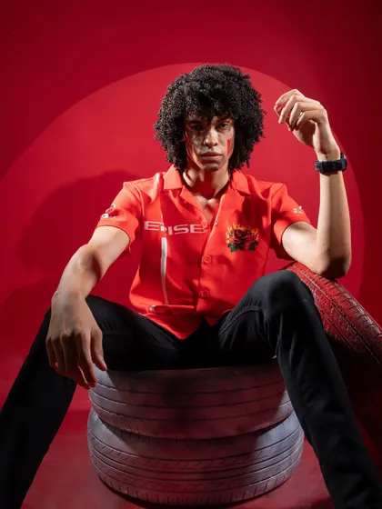 A powerful portrait of the male model for the Cerise Clothing shoot. The dramatic red lighting and confident pose perfectly match the brand's high-energy vibe.