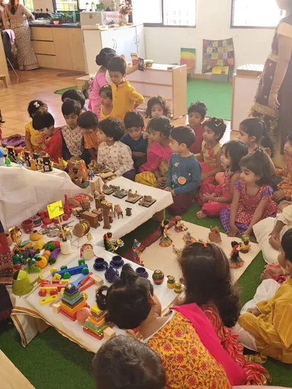 Children sit together to learn about the significance of the 'Golu' display.