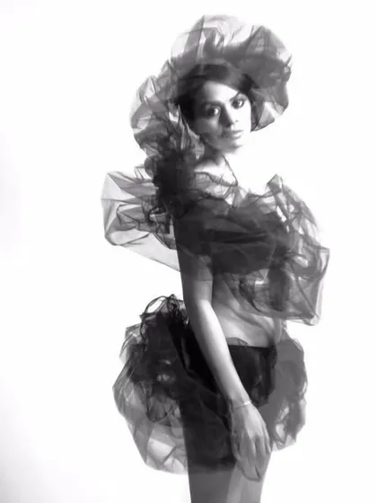 Another take from the monochrome draping series. The pose and the flowing fabric create a sense of movement and abstract form.