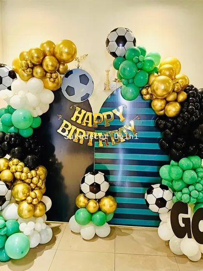 A bright, clear shot of the football decoration, highlighting the chrome gold and green balloons.