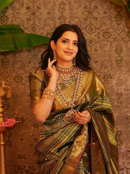 A smiling portrait of the model, her hand gently touching her hair, her expression warm and inviting.