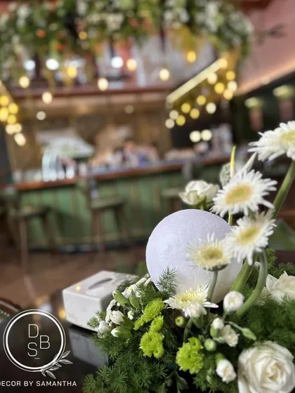 Centerpieces taking center stage. For the KGA's 50th year celebration, we used playful moon orbs within the floral arrangements to add a touch of drama and whimsy.