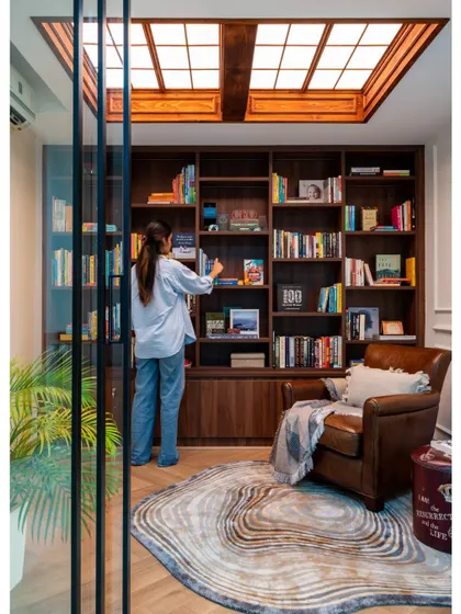 This image from a publication feature highlights the home library in "Villa Tranquility." The custom-designed skylight and built-in shelving are key features that make this room a standout space.