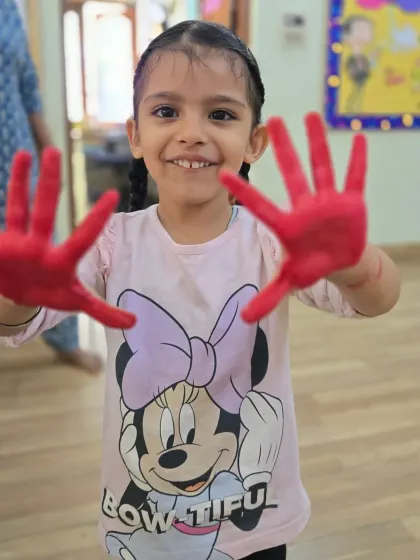 A big, happy smile from one of our little Asters during a hand printing art project. It is wonderful to see them so engaged and proud of their messy hands.