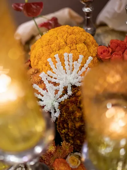 A detailed shot of the textured marigold sphere, accented with delicate, star-shaped jasmine beadwork. This is a testament to the intricate hand-craftsmanship that goes into our designs.