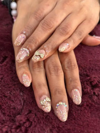 This is what we mean by a 'glow-up'. These glitter extensions feature delicate, hand-placed 3D bows and crystals for a look that's pure luxury. Perfect for when you want your nails to be the main event.
