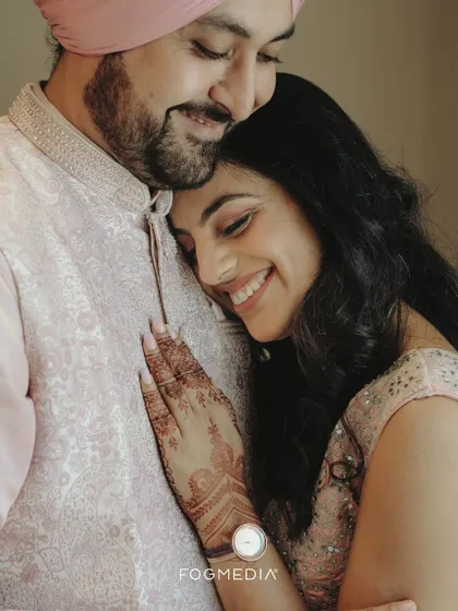 A tender moment of embrace between a newly engaged couple, their soft smiles reflecting their deep affection.