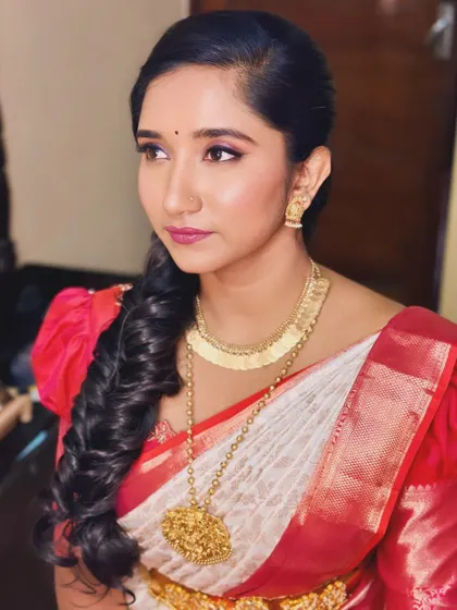 A close-up profile shot of Lakshitha, highlighting her flawless skin and intricate hairstyle.