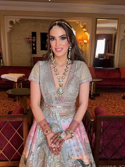 The bride looking radiant and happy with her floral half-up hairstyle for her destination wedding.