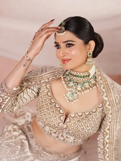 A confident and glamorous portrait of the bride, showcasing her stunning jewelry and the elegant updo that completes the look.