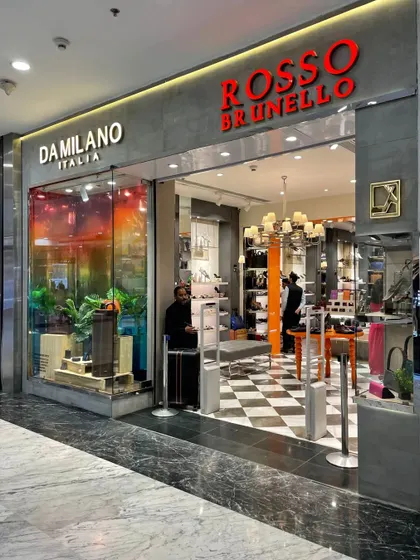 Another shot of the dual-brand storefront, highlighting the contrasting aesthetics of the two brands within a single architectural frame.
