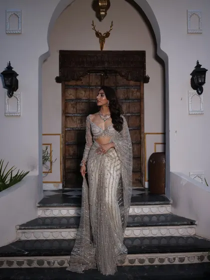 Another view of the silver saree, showcasing its beautiful drape and how it catches the light.
