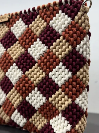 A side angle of the checkered bag, showing its depth and the quality of the cotton cord.