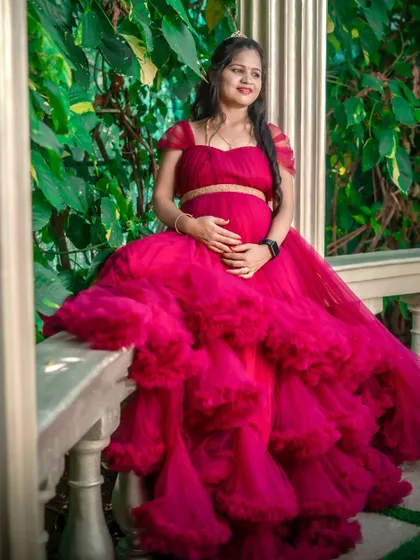 This two-piece magenta gown with a full, tiered skirt is a showstopper. It's a glamorous choice that photographs beautifully, especially in lush, green settings.