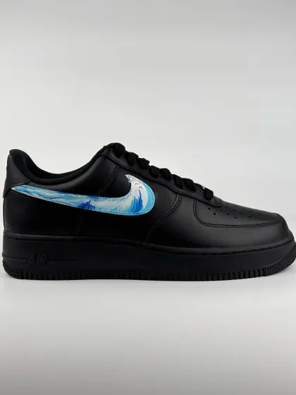 The other shoe in the pair, featuring a water wave swoosh.