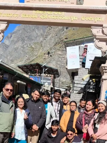 **A Joyful Group at Badrinath.** A large group of our travelers smiling for a photo at the entrance of the Badrinath temple complex.
