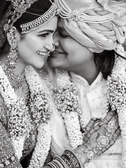 A timeless black and white portrait of the couple sharing an intimate moment after their vows. The texture of their garlands and outfits adds to the beauty.