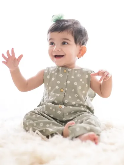 A simple, joyful portrait of a baby girl on a soft, fluffy rug. The clean, bright background and her happy expression make for a beautiful and timeless image.