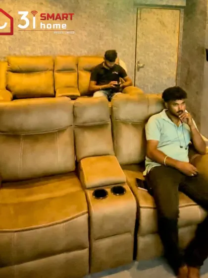 A shot of a 5.1.2 compact home cinema, with clients relaxing in the comfortable, tiered recliners.