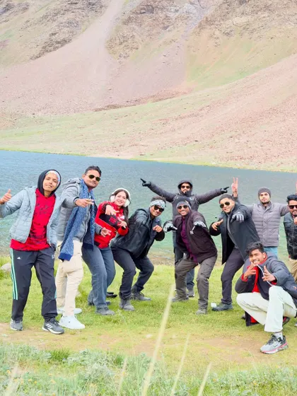 The group enjoying a fun, relaxed moment together by the lake. These trips are as much about the people you meet as the places you see.