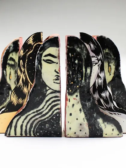A side view of the 'Confrontation' pieces, showing the different faces and patterns.