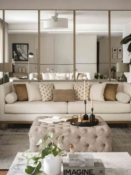 A closer look at the sofa against the mirrored wall, showing how we use reflective surfaces to enhance light and create a sense of spaciousness.