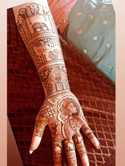 A unique bridal design featuring a portrait of the bride on the palm, along with other traditional wedding scenes like the doli.