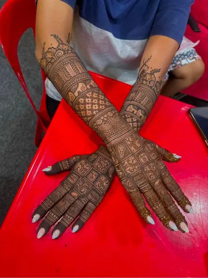 A very dense and intricate design with a focus on grid and checkerboard patterns, perfect for brides who love full coverage.