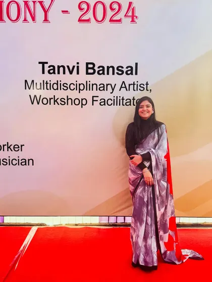 Standing by the event banner at my school's annual prize distribution ceremony. It was surreal to see my name listed as a multidisciplinary artist and workshop facilitator.