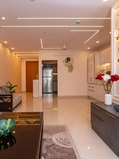 A tour of a vibrant 3BHK in Bangalore. The open-plan living area is designed with clean lines and modern ceiling lights, creating a bright and welcoming space.
