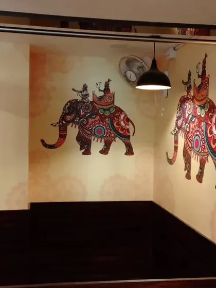 Another view of the decorated elephant mural, showing its placement in a corner.