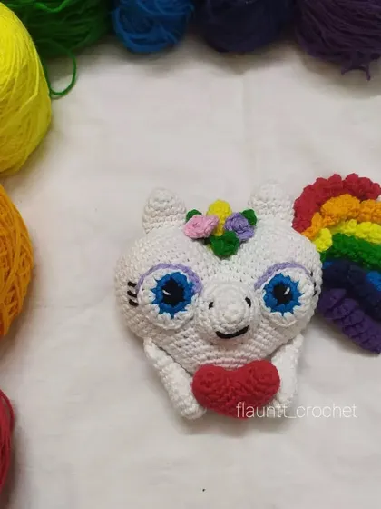 My Valentine's special unicorn heart, surrounded by the rainbow of yarns I used to make it. This is a unique, handmade gift perfect for showing someone you care.