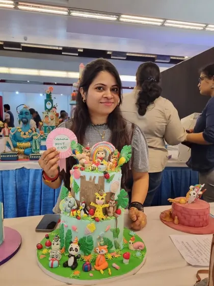 Beaming with happiness after receiving an award for my jungle cake. This recognition fuels my passion for creating unique and detailed edible art.