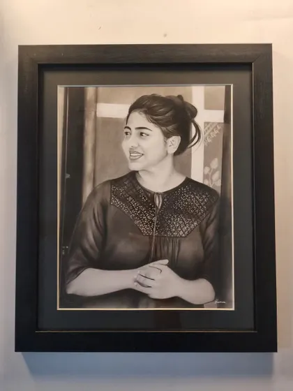 The portrait in a classic black frame.