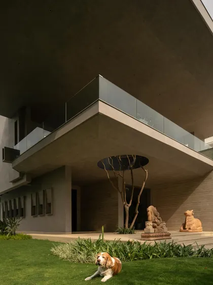 The integration of nature is a key theme, seen in the voids cut for trees and the placement of art and sculpture in the garden. The architecture frames and celebrates the natural environment.