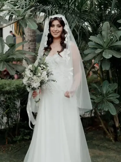A full view of this beautiful bride in her garden setting. Her hairstyle and natural makeup look were designed to feel effortless and complement the outdoor Goa wedding vibe.