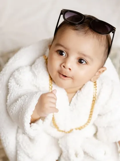 A close-up shot of the boss baby, with his sunglasses pushed up, looking cool and confident.