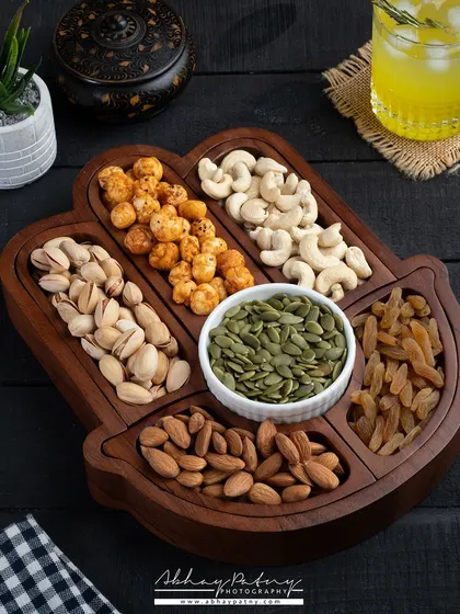 Here, I've styled a beautiful wooden platter with an assortment of healthy dry fruits and nuts. This kind of shot is perfect for showcasing homeware or gifting products.