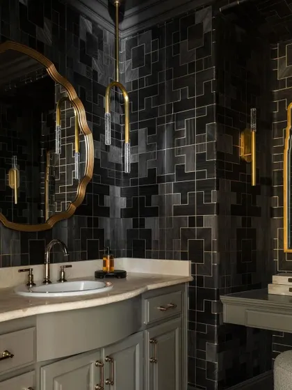 This atmospheric powder room showcases the elaborate patterns of our Fretwork collection from Phillip Jeffries. The geometric wood design in Commanding Charcoal creates a bold, moody, and luxurious feel.