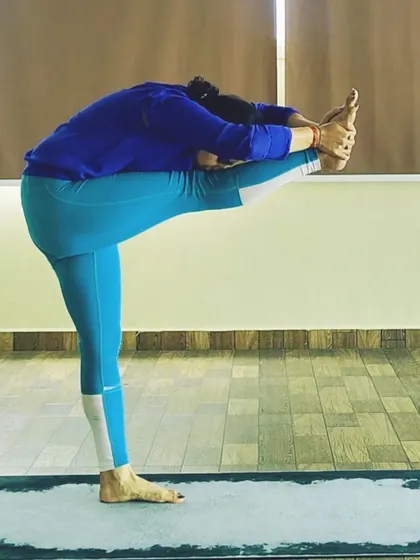 Dandayamana Janu Sirsasana, or Standing Head to Knee Pose, is a challenging posture that improves flexibility in the hamstrings and strengthens the legs and core.