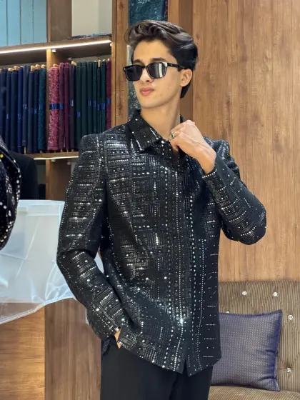 A client looking sharp in a sequined black jacket in our store. It's the perfect spot to find your next party outfit.