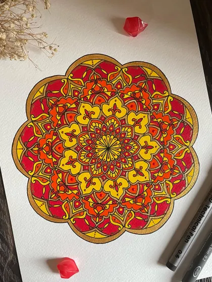 Another look at this fiery, ornate mandala. The gold outline really helps to define the shapes and add a touch of elegance.