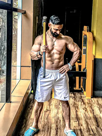 Holding a sledgehammer in the gym. We use a variety of tools to build functional strength and power.