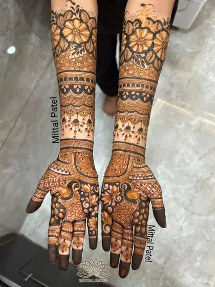 A beautiful example of a full-hand floral design, perfect for an engagement party or for a bridesmaid. The combination of bold flowers on the forearm and delicate peacock motifs on the palm creates a balanced and stunning look.