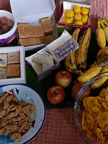 A spread of delicious Onam snacks, including banana chips and various sweets.