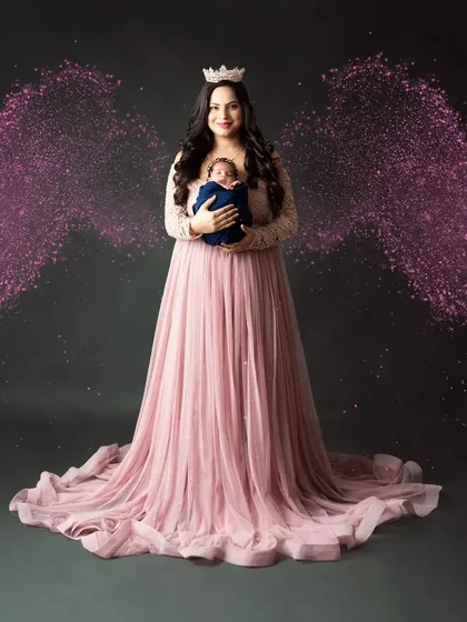 A mother's love is a work of art. A beautiful portrait of a new mom holding her baby, complete with magical angel wings.