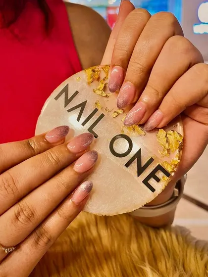 A closer view of the beautiful glitter ombré nails, showcasing the seamless transition of color and the delicate shimmer.