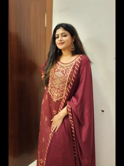 A standing pose in the maroon anarkali, showing its full length and rich color.