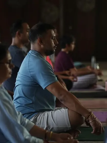 A close up of students in meditation during our community event. These are the moments that ground us and expand our practice beyond the individual mat.