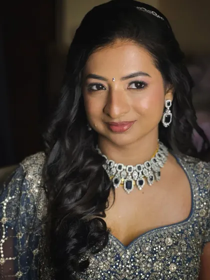 A beautiful portrait of a bride at her reception. The makeup is soft and elegant, with a subtle smokey eye that adds a touch of glamour.